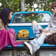 characters sitting in a blue truck